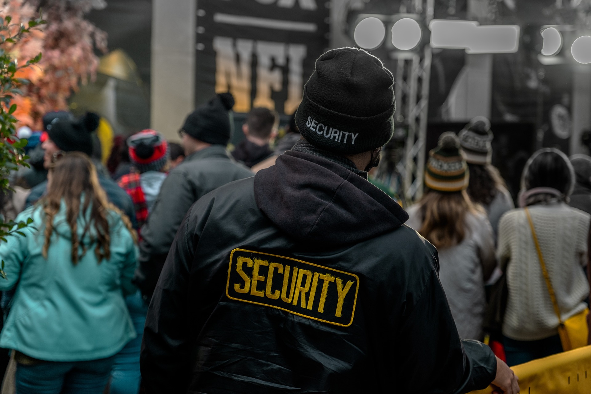 security guard in crowd wearing beanie