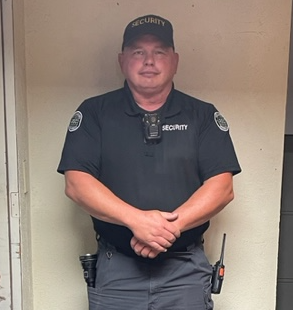 shawn standing in a security uniform